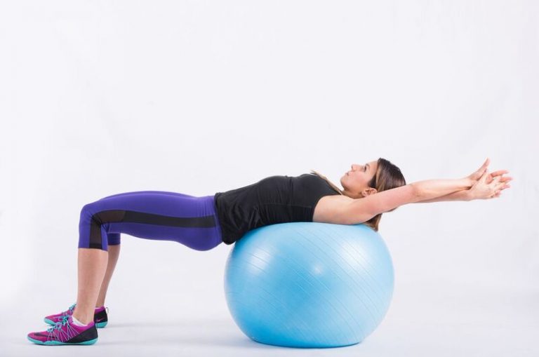 Shoulder blades pressed against the ball with the arms crossed behind the head